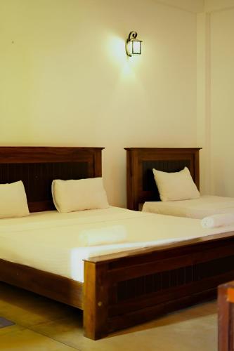 two beds sitting next to each other in a room at Bundala Bird View in Hambantota