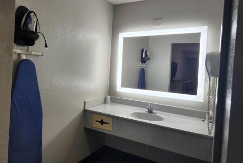 a bathroom with a sink and a mirror at Days Inn by Wyndham Ocean Springs in Ocean Springs