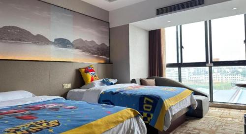 a bedroom with two beds and a large window at Guilin Manhatton Hotel Tianjie in Guilin