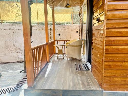 a porch of a house with a table and chairs at WOW STAYZ2 Ashoka Grand in Dalhousie