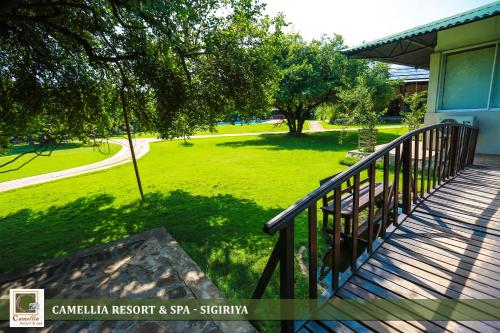 a balcony of a house with a green yard at Camellia Resort And Spa Sigiriya - Sri Lanka in Avudangawa