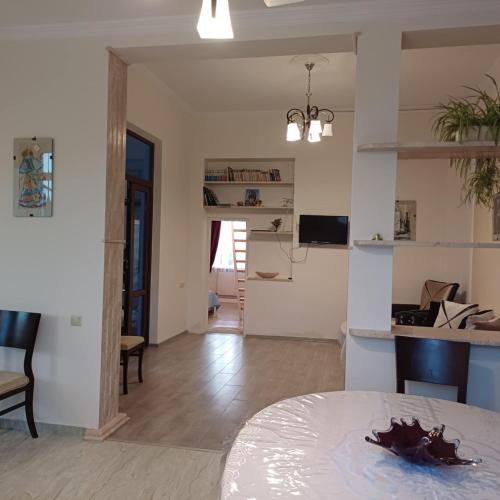 a living room with a table and a dining room at BIS-A Guesthouse in Makhinjauri