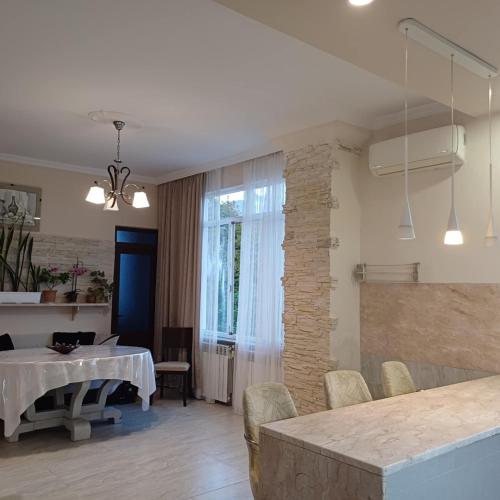 a kitchen and dining room with a table and chairs at BIS-A Guesthouse in Makhinjauri