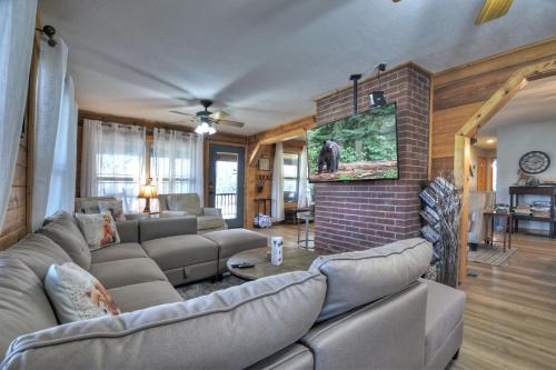 a living room with a couch and a brick wall at Moon Tower Cabin - Beautiful Water Views Firepit More in Blairsville