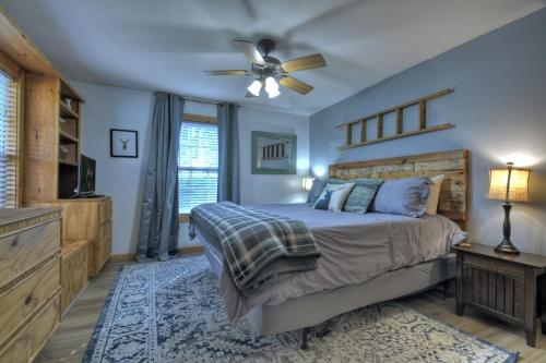 a bedroom with a bed and a ceiling fan at Moon Tower Cabin - Beautiful Water Views Firepit More in Blairsville
