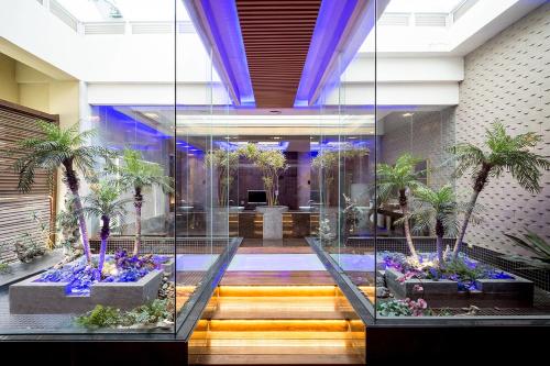 a lobby with palm trees and flowers in a room at Norway Forest Villa Motel in Taipei