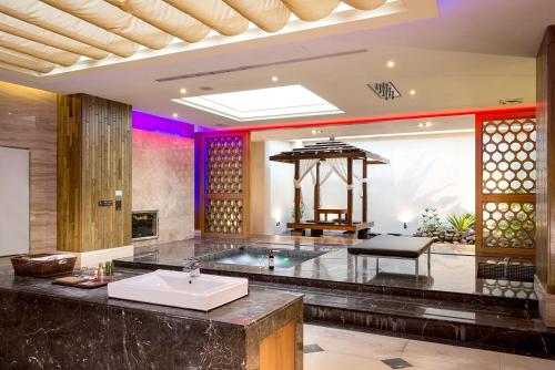 a large bathroom with a sink and a table at Norway Forest Villa Motel in Taipei