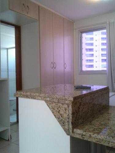 a kitchen with pink cabinets and a counter top at #Flats Studio 45 Bueno Oeste in Goiânia