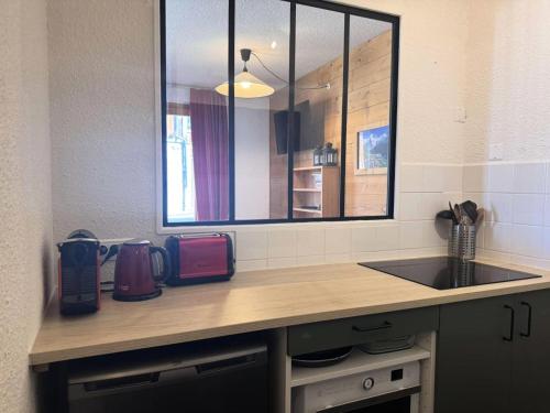 un comptoir de cuisine avec un évier et une fenêtre dans l'établissement Résidence Souche - La Souche 10 - Agréable 2 pièces, terrasse skis aux pieds MAE-5114, à Valmorel