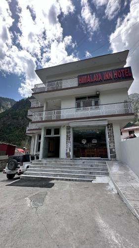 a building with stairs in front of a building at Himaliya Inn Hotel & Restaurant in Mināwar