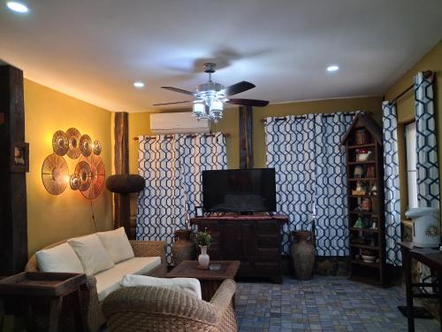 a living room with a couch and a tv at On The Mekong Resort in Luang Prabang