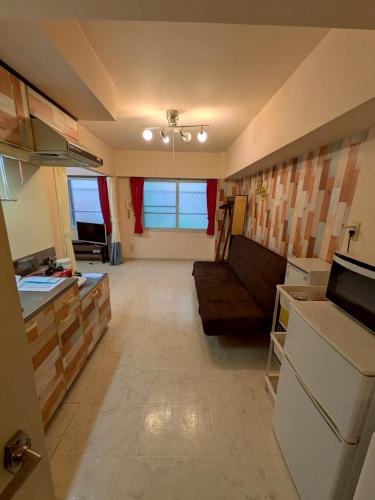 sala de estar amplia con sofá y cocina en RoseMarieSapporo, en Sapporo
