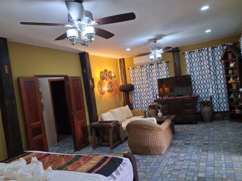 a living room with a bed and a tv at On The Mekong Resort in Luang Prabang