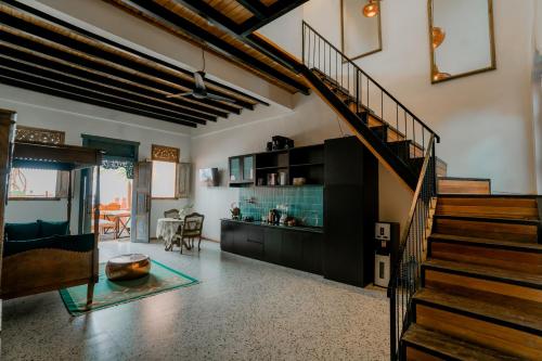 a room with a staircase and a living room at La Marrocco Villas in Nusa Penida