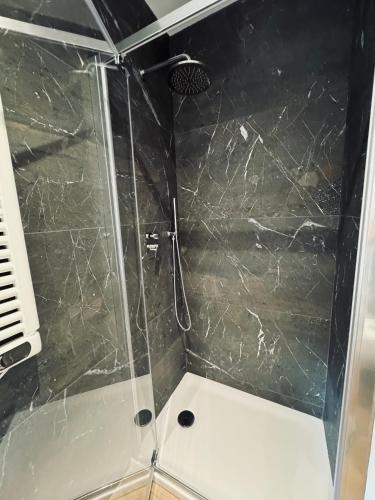 a shower with a glass door in a bathroom at Residenza esclusiva appena costruita in Imola