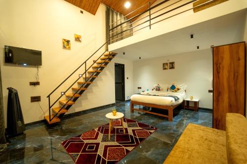 a bedroom with a bed and a staircase at The Enchanted Nest By Privy Stays in Alibag