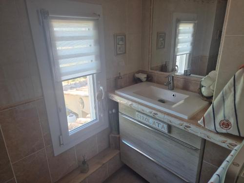 a bathroom with a sink and a window at Gites Colline De Sollies in Salernes
