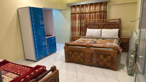 a bedroom with two beds and a refrigerator at Himaliya Inn Hotel & Restaurant in Mināwar