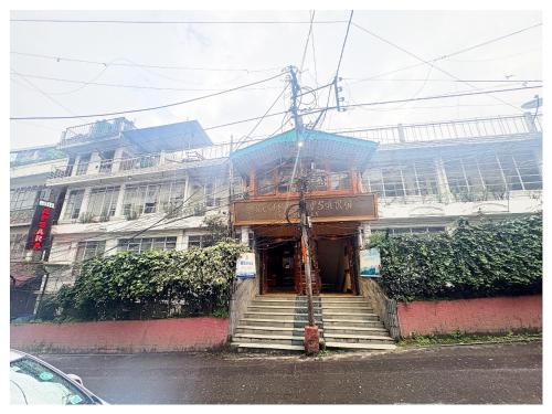 a building with stairs in front of a building at Darjeeling Mall is 700 m From Apsara Darjeeling Pure veg in Darjeeling