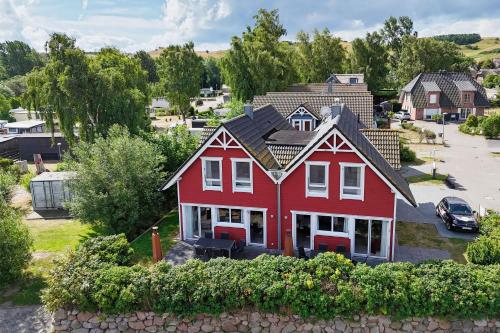an aerial view of a red house at Ferienhaus TimpeTe Haus Backbord - Terrasse, Meerblick, Sauna in Gager