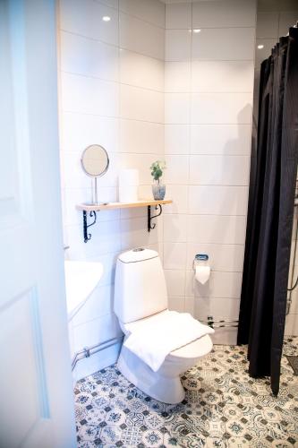 a bathroom with a toilet and a sink at Park Hotel Linköping Fawlty Towers in Linköping