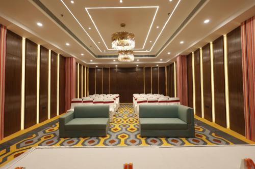 a conference room with chairs and tables and a chandelier at Zone Connect by The Park Patna 
