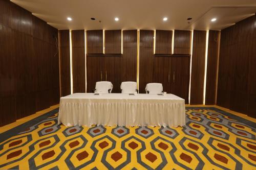 a meeting room with a table and chairs in it at Zone Connect by The Park Patna 