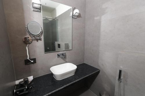 a bathroom with a sink and a mirror at Zone Connect by The Park Patna 
