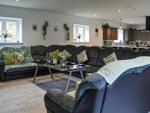 a living room with a couch and a table at The Stables in Goxhill