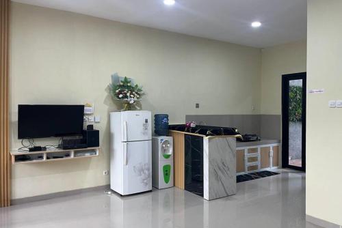 a living room with two refrigerators and a tv at Rooms at Deceva by Panorama Villas, Batu Malang in Batu