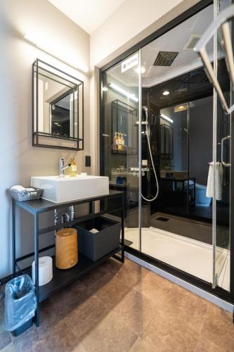 a bathroom with a sink and a shower at HOTEL TABARD TOKYO in Tokyo