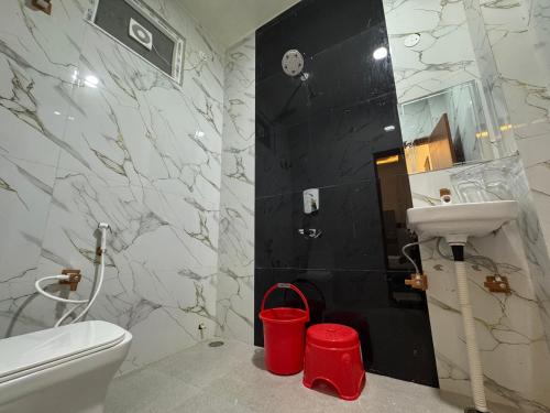 a bathroom with a white toilet and a sink at Satya Nikunj INN in Vrindāvan