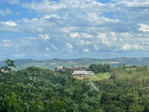 a house on top of a hill with trees at La casa di Noah in Bene Vagienna