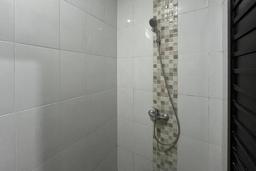 a bathroom with a shower with a shower head at Rooms at Deceva by Panorama Villas, Batu Malang in Batu