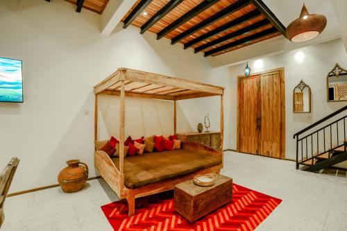 a bedroom with a bed with a wooden canopy at La Marrocco Villas in Nusa Penida