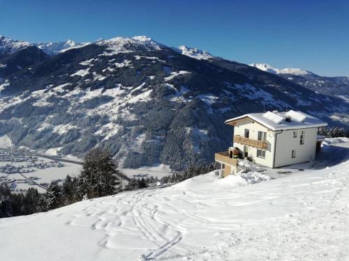 a house on top of a snow covered mountain at Haus Angela in Rohrberg