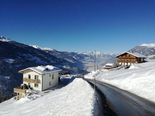 a house in the snow next to a road at Haus Angela in Rohrberg