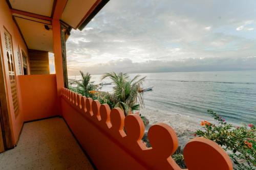a balcony with a view of the ocean at La Marrocco Villas in Nusa Penida