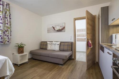 a living room with a couch in a kitchen at Haus Angela in Rohrberg