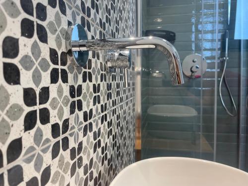 a bathroom with a shower with a sink and a toilet at Titanya - Bed And Breakfast Di Galatea Casa Vacanze in Corsano