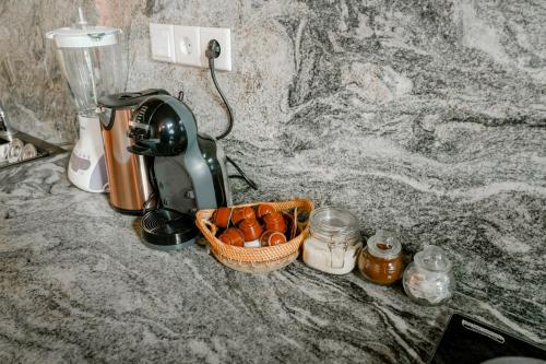 a mixer sitting on a counter with a basket of food at La Marrocco Villas in Nusa Penida