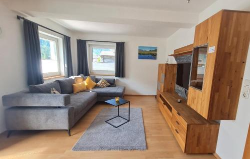 a living room with a couch and a tv at Haus Alpenheim Apartment 3 in Tux