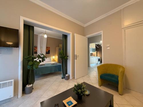 a living room with a couch a table and a bed at Endless summer,Agia Triada in Agia Triada