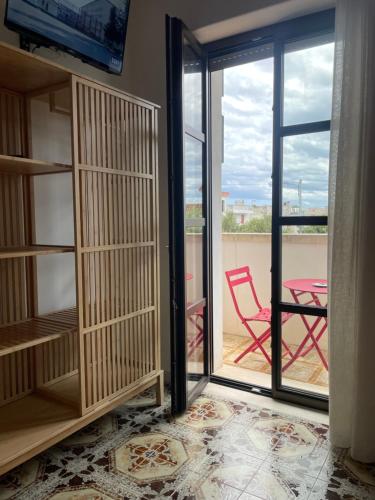 a room with a sliding glass door leading to a patio at Titanya - Bed And Breakfast Di Galatea Casa Vacanze in Corsano
