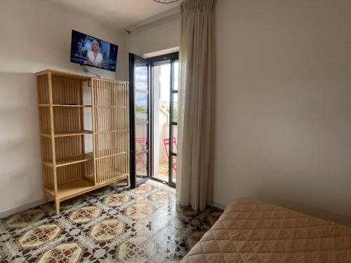 a room with a bed and a sliding glass door at Titanya - Bed And Breakfast Di Galatea Casa Vacanze in Corsano