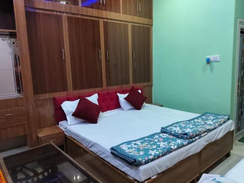 a bedroom with a large bed with wooden cabinets at Shri Shiva Homestay by VM Stays in Varanasi