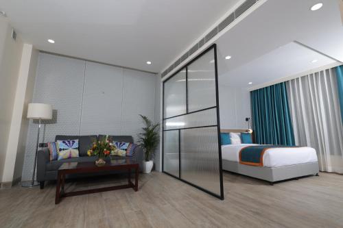 a bedroom with a bed and a couch and a table at Zone Connect by The Park Patna 