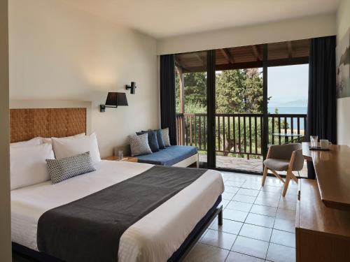 A bed or beds in a room at Aeolos Beach Resort