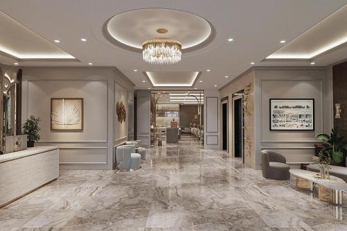 a lobby with a hair salon with a chandelier at Minasi Grand Hotel in Hanoi