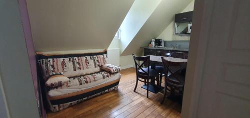 a living room with a couch and a table at Manoir Le Castel & Villa Beaumaris in Saint Malo